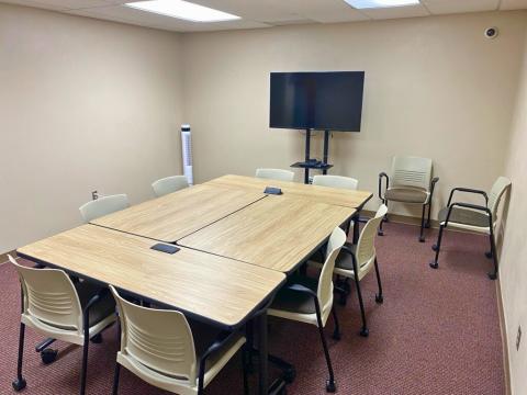 conference room with TV, tables, chairs