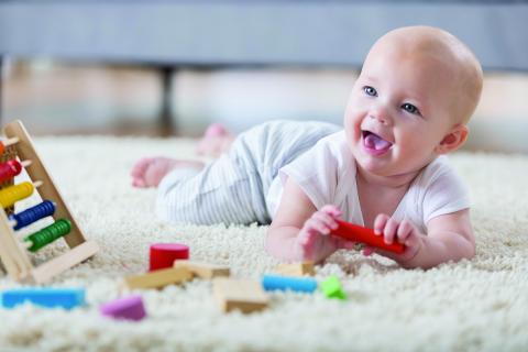 baby on tummy with toys