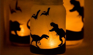 glass jars glowing with dinosaur silhouettes 