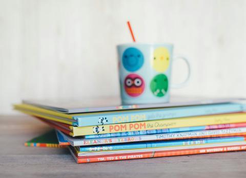 Stack of books with mug on top